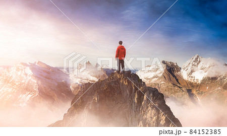 Adventurous Man on top of a rocky mountain. 84152385