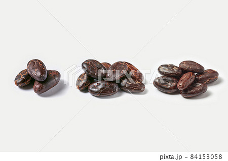 Few piles of raw organic cacao beans Few piles of raw organic cacao beans 84153058