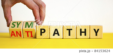 From antipathy to sympathy. Businessman turns cubes and changes the word 'antipathy' to 'sympathy'. Beautiful white background. Copy space. Psychological and antipathy or sympathy concept. From antipathy to sympathy. Businessman turns cubes and changes the word 'antipathy' to 'sympathy'. Beautiful white background. Copy space. Psychological and antipathy or sympathy concept. 84153624