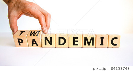 Pandemic or twindemic symbol. Doctor turns wooden cubes and changes the word 'pandemic' to 'twindemic'. Beautiful white background, copy space. Medical and pandemic or twindemic concept. Pandemic or twindemic symbol. Doctor turns wooden cubes and changes the word 'pandemic' to 'twindemic'. Beautiful white background, copy space. Medical and pandemic or twindemic concept. 84153743