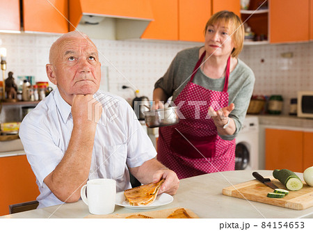 Upset senior man with disgruntled wife Upset senior man with disgruntled wife 84154653