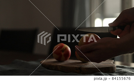 man cutting ripe nectarines on olive board in early morning man cutting ripe nectarines on olive board in early morning 84155676