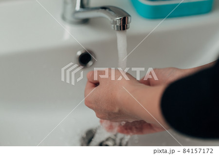 The Girl Washes Her Hands to Avoid Infection With the Virus COVID-19 84157172