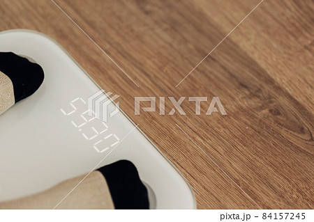 Girl Measures Weight on Smart Scales. Modern Electronic Device. 84157245