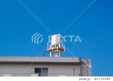 青空を背にした白いマンションの高架水槽 84159486