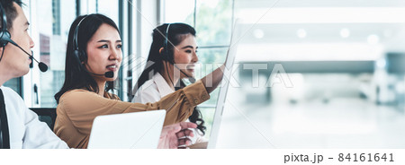 Business team wearing headset working actively in office Business team wearing headset working actively in office 84161641