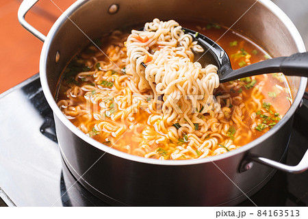 Asian spicy instant noodles soup cooking in hot pot 84163513