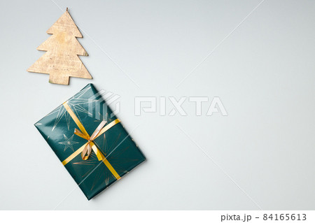 Christmas gift wrapped in paper with bow top view 84165613