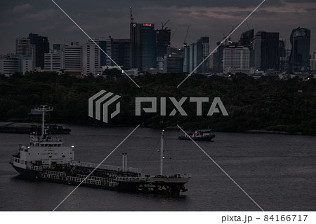 Chao Phraya River view, has cargo ships docked at the middle river. The background is skyscraper in the business district in Bangkok. 84166717