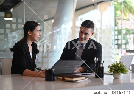 Businesswoman discussing project planning with her colleague at modern office. Businesswoman discussing project planning with her colleague at modern office. 84167171
