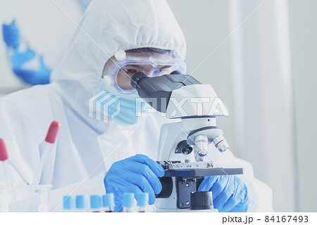Male Scientist look into Microscope research in science laboratory. Asian scientist looking equipment laboratory chemistry labs. Covid-19 coronavirus biochemistry research experiment vaccine concept 84167493