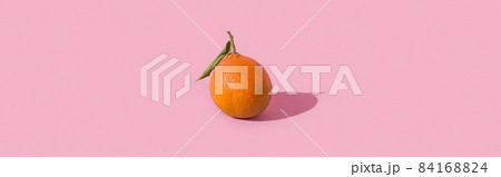 Fresh tangerine, clementine isolated on pink background with hard shadow. Pop art design, creative summer concept. Citrus in minimal style. 84168824