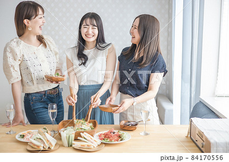 家でパーティーする女性たち（サラダ・取り分ける） 84170556