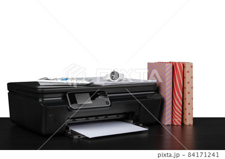 Printer and stack of books on black table against white background Printer and stack of books on black table against white background 84171241
