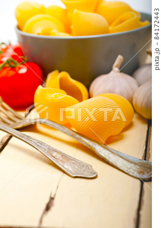 Italian snail lumaconi pasta with tomatoes 84172443