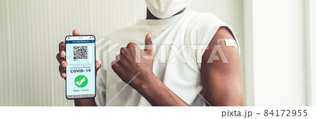 African American teenager shows vaccine passport on mobile phone 84172955