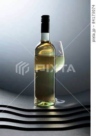 Bottle and glass of white wine. Bottle and glass of white wine. 84173074