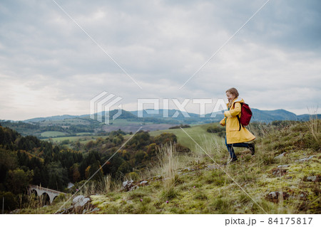 Happy little girl running on the top of mountain outdoors in autumn. Happy little girl running on the top of mountain outdoors in autumn. 84175817