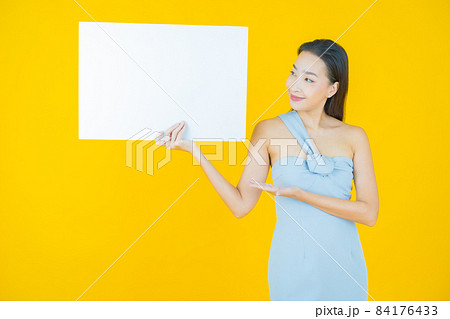 Portrait beautiful young asian woman with empty white billboard 84176433