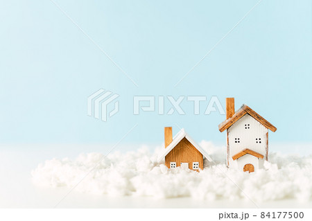 Happy New Year and Merry Christmas banner. Festive blue background with toy wooden house, snow, rustic Christmas village and decoration. Copy space for winter holidays greeting card 84177500