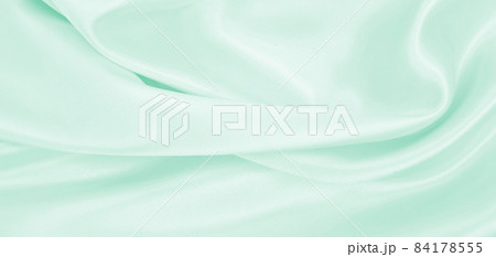 Smooth elegant green silk or satin luxury cloth texture as abstract background. Luxurious background design 84178555