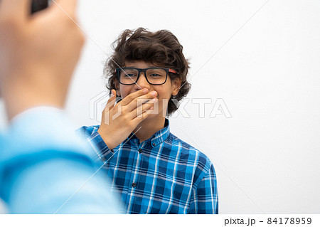 portrait of smart looking arab teenager with glasses wearing a hat in casual school look isolated on white copy space portrait of smart looking arab teenager with glasses wearing a hat in casual school look isolated on white copy space 84178959