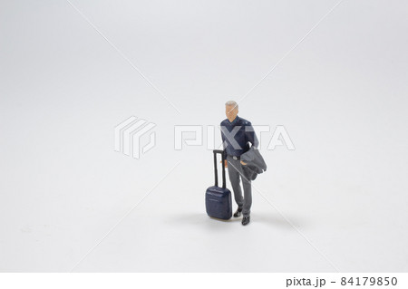 a mini of good looking figure with suitcase walking a mini of good looking figure with suitcase walking 84179850