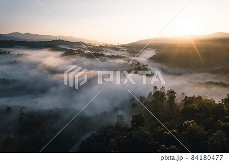 Flying above the clouds sunrise and fog Flying above the clouds sunrise and fog 84180477