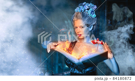 Christmas fairy tale concept. Snow queen calling winter use book of spells 84180872