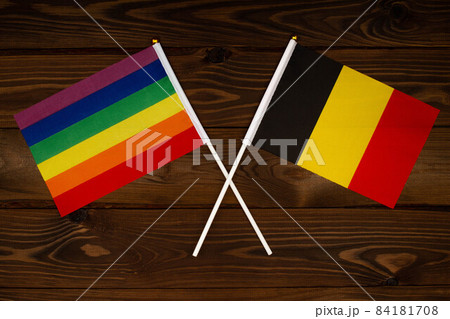 Rainbow flag LGBT and flag of Belgium on beautiful brown background with wooden texture. LGBT Pride Month. LGBTQ. LGBTQIA. Human rights concept. Close Up. Top view Rainbow flag LGBT and flag of Belgium on beautiful brown background with wooden texture. LGBT Pride Month. LGBTQ. LGBTQIA. Human rights concept. Close Up. Top view 84181708