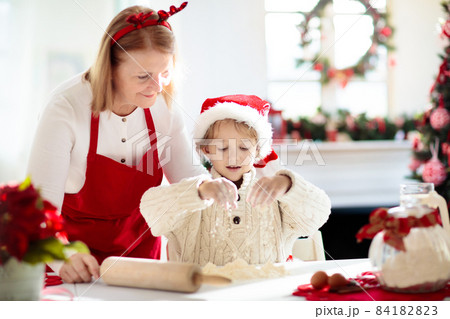 Family baking Christmas cookies. Kids Xmas fun. Family baking Christmas cookies. Kids Xmas fun. 84182823