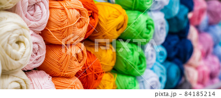 Multi-colored balls of yarn for knitting. Woolen threads for needlework. Banner format Multi-colored balls of yarn for knitting. Woolen threads for needlework. Banner format 84185214