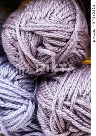 Background from multi-colored fluffy woolen threads for knitting closeup. Background from multi-colored fluffy woolen threads for knitting closeup. 84185215
