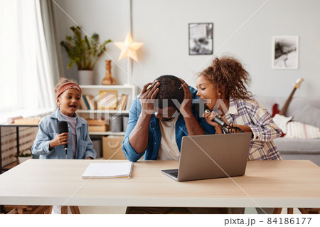 Father Struggling to Work from Home Father Struggling to Work from Home 84186177
