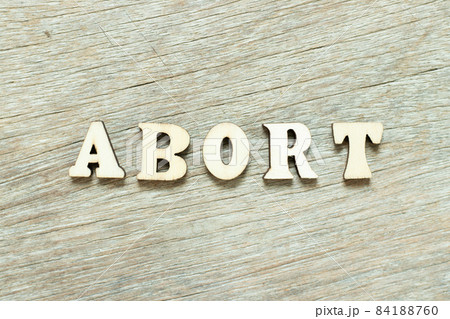 Alphabet letter in word abort on wood background 84188760