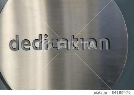 engraving a cnc machine on a piece of metal. Engraving dedication text engraving a cnc machine on a piece of metal. Engraving dedication text 84189476