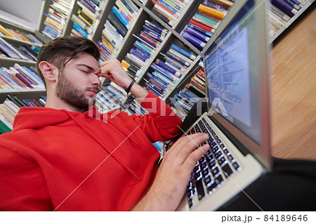 the students uses a notebook, laptop and a school library 84189646