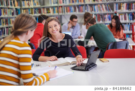the student uses a notebook and a school library 84189662