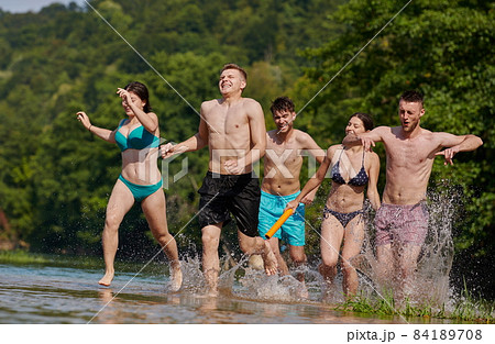 group of happy friends having fun on river 84189708