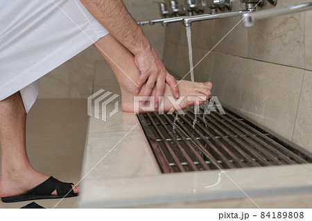 A Muslim takes ablution for prayer. Islamic religious rite A Muslim takes ablution for prayer. Islamic religious rite 84189808