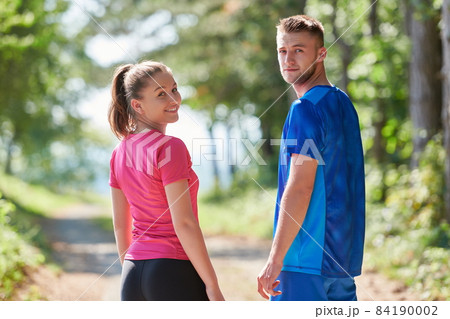couple enjoying in a healthy lifestyle while jogging on a country road couple enjoying in a healthy lifestyle while jogging on a country road 84190002