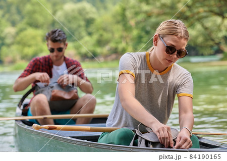 friends are canoeing in a wild river friends are canoeing in a wild river 84190165