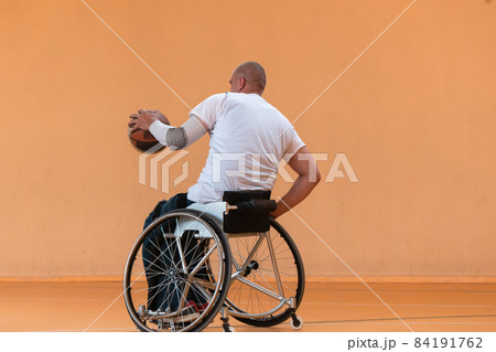 disabled war veterans in action while playing basketball on a basketball court with professional sports equipment for the disabled 84191762