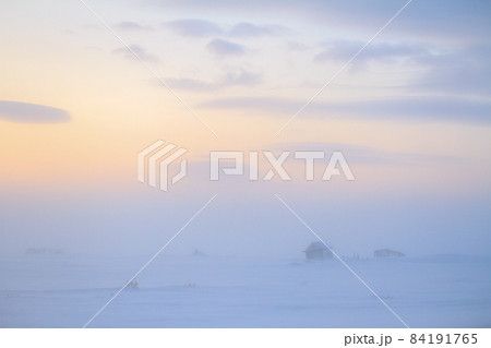 Winter landscape with a small abandoned house in a snow-covered tundra. Winter landscape with a small abandoned house in a snow-covered tundra. 84191765