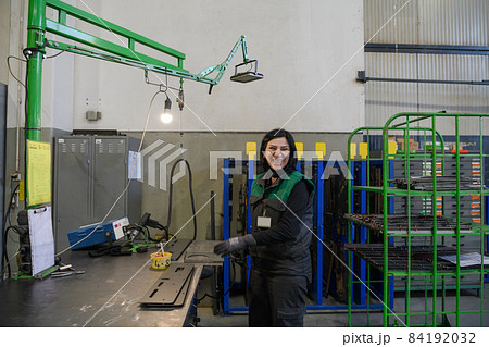 a woman working in the modern metal production and processing industry welding the product and prepares it for a cnc machine a woman working in the modern metal production and processing industry welding the product and prepares it for a cnc machine 84192032