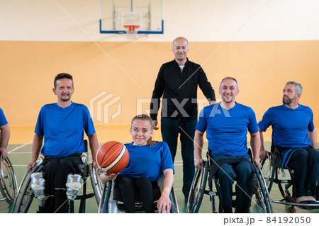 photo of the basketball team of war invalids with professional sports equipment for people with disabilities on the basketball court 84192050
