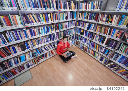 the students uses a notebook, laptop and a school library 84192241