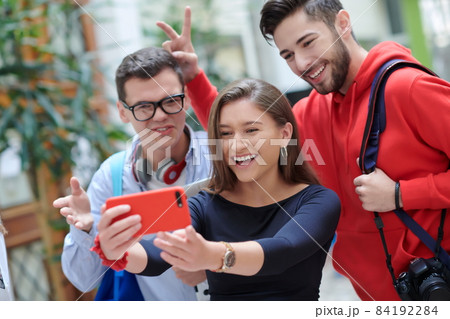 Group of multiethnic teenagers taking a selfie in school Group of multiethnic teenagers taking a selfie in school 84192284