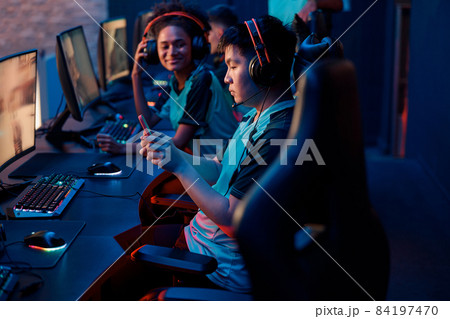 Competitive gamer playes on smartphone in cyber club 84197470