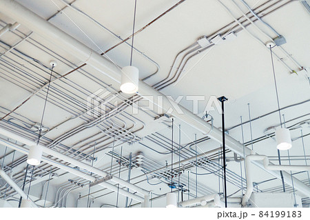 white rustic ceiling background with pipes and conduits white rustic ceiling background with pipes and conduits 84199183